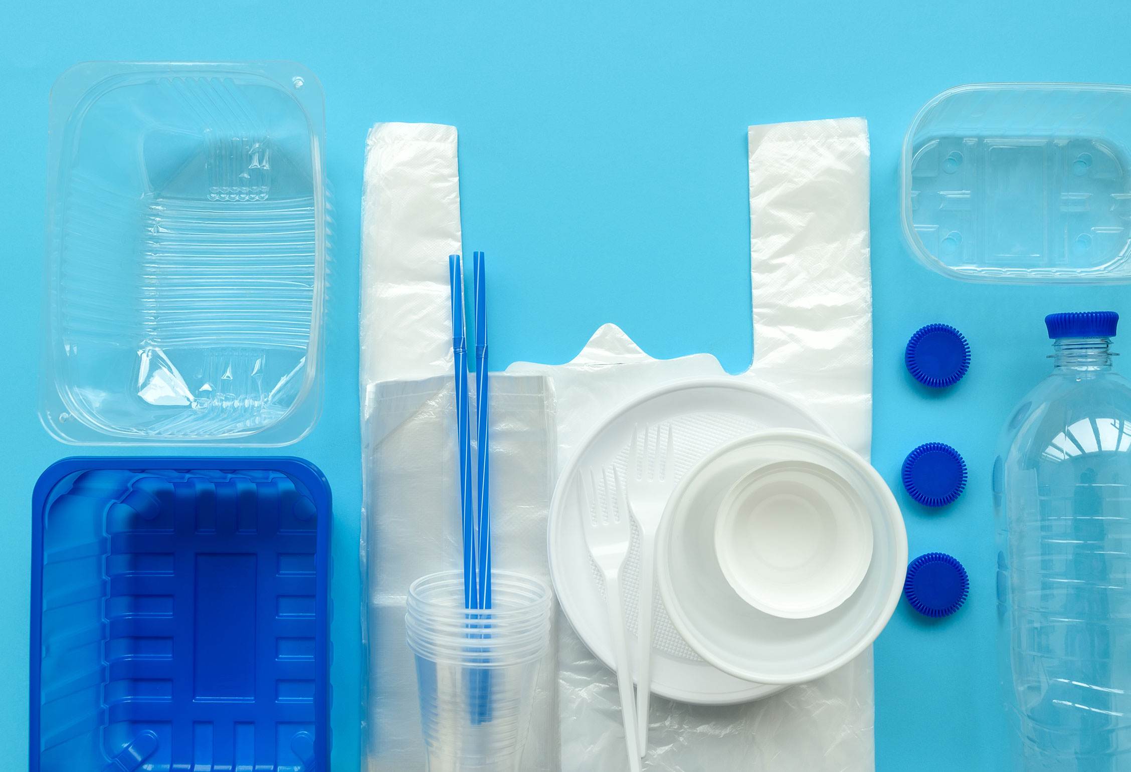 Plastic containers and items neatly arranged on a blue surface